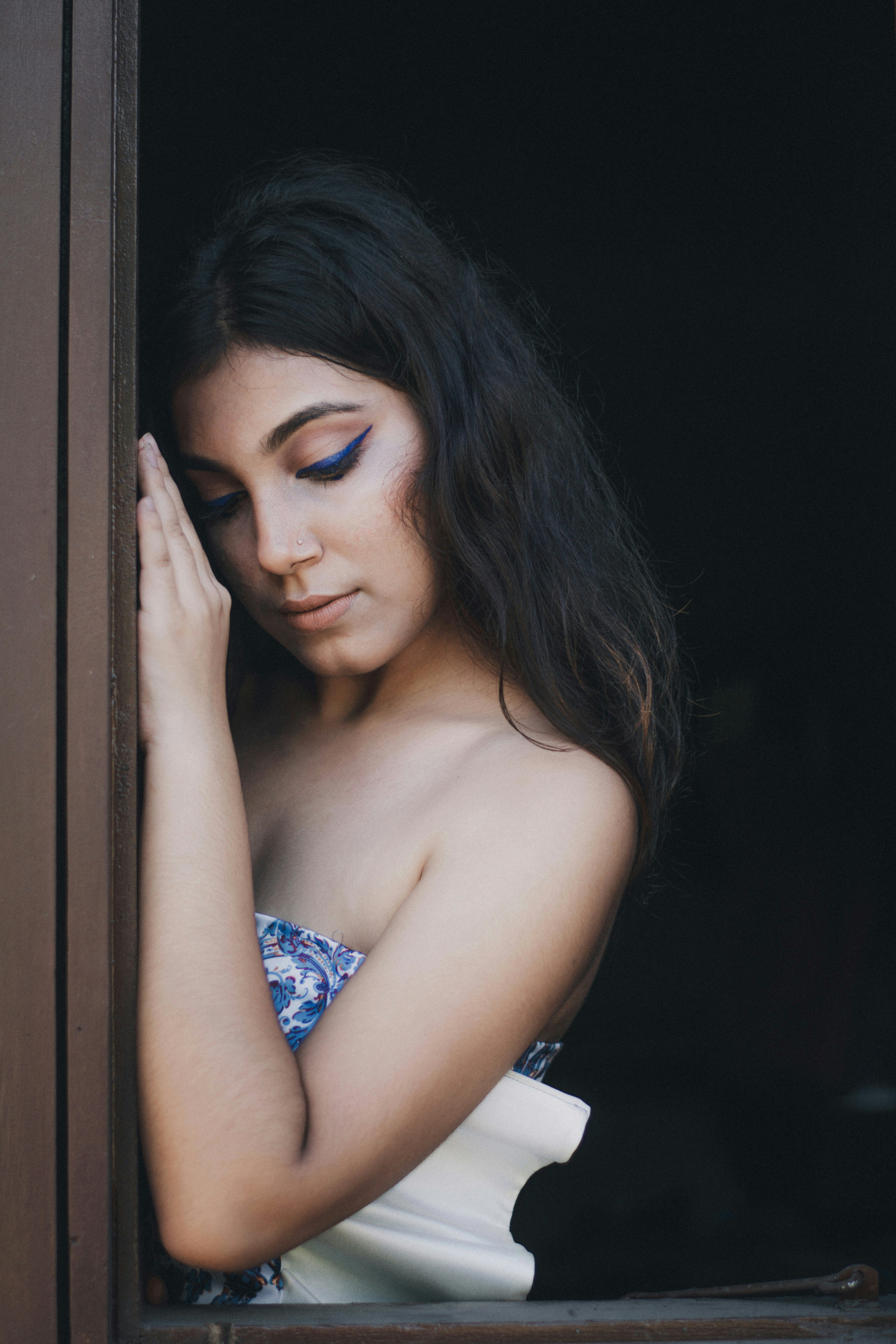 woman in blue and white floral tube dress